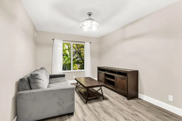 a bedroom with bed tv and a window