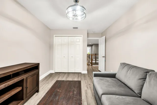 a bedroom with a large bed and a chandelier