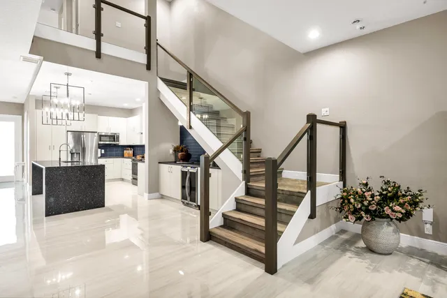 a living room with furniture flat screen tv and a large window