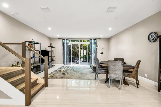a view of a livingroom with furniture and staircase