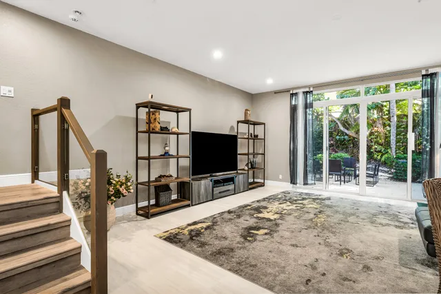 a spacious bedroom with a bed and a flat screen tv