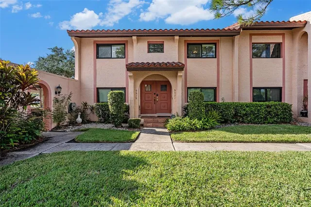 a front view of a house with a garden