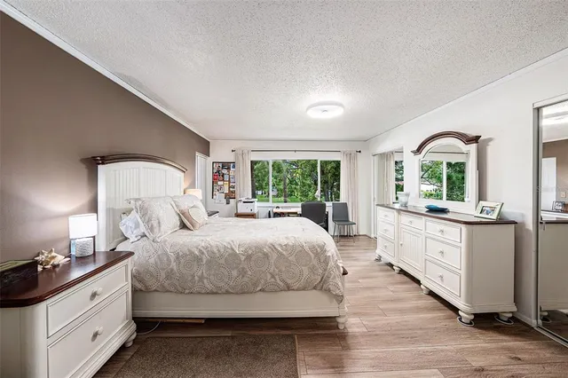 a large bedroom with a large bed and windows