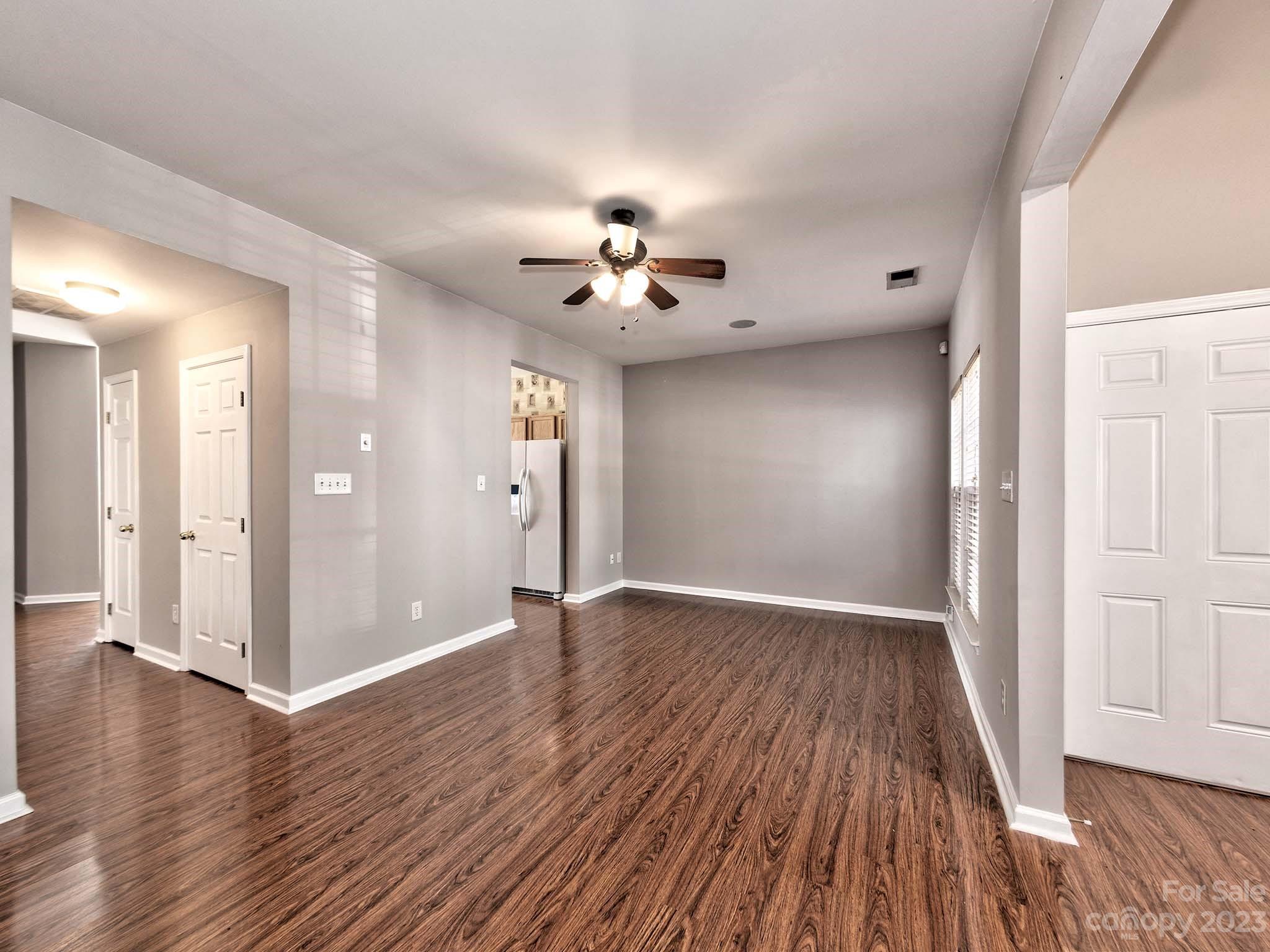 4849 Prosperity Ridge Road Charlotte, NC 28269 - Photo 12 of 40 a view of an empty room with wooden floor and a ceiling fan