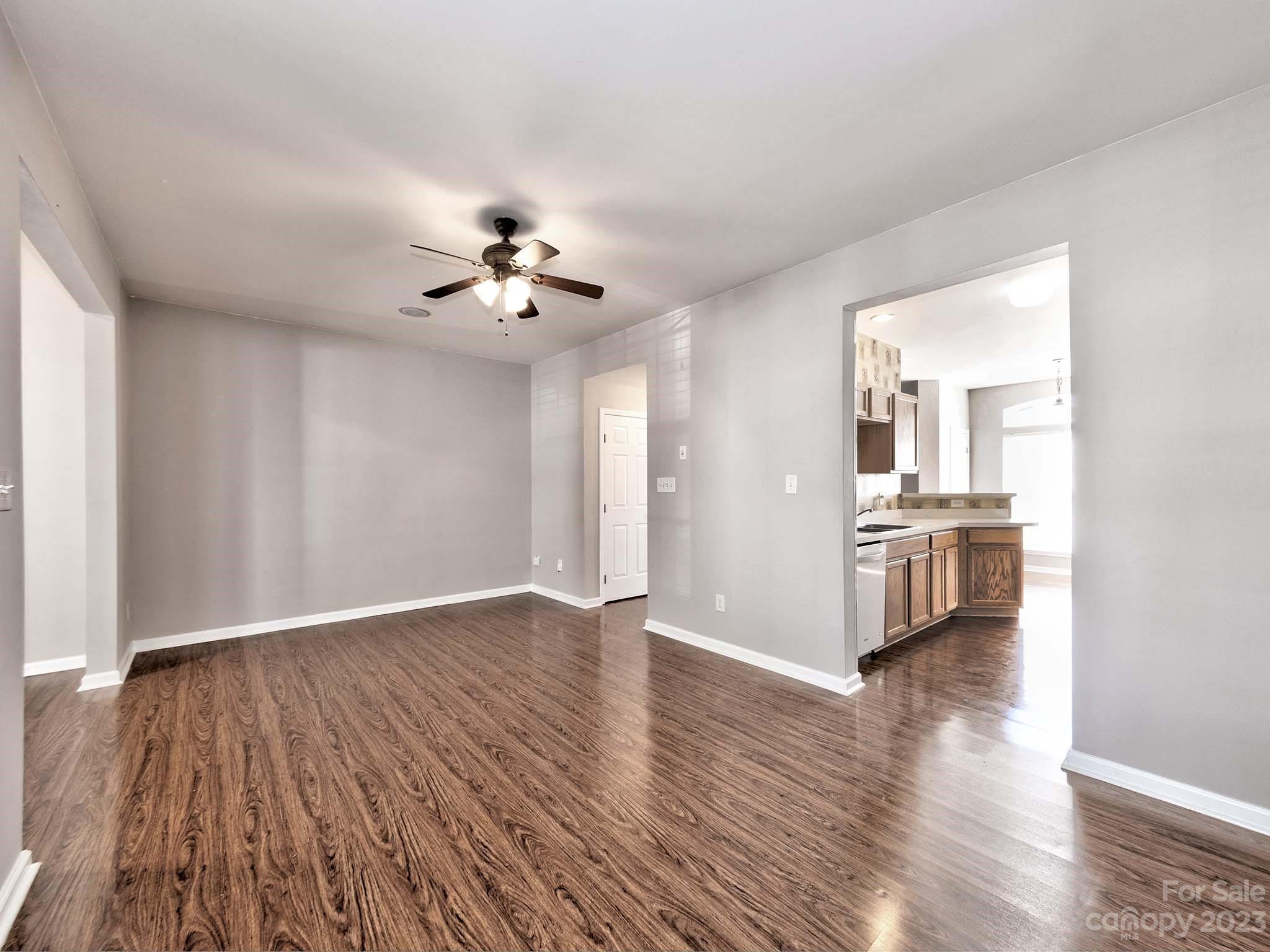 4849 Prosperity Ridge Road Charlotte, NC 28269 - Photo 13 of 40 a view of a kitchen with an empty room and wooden floor