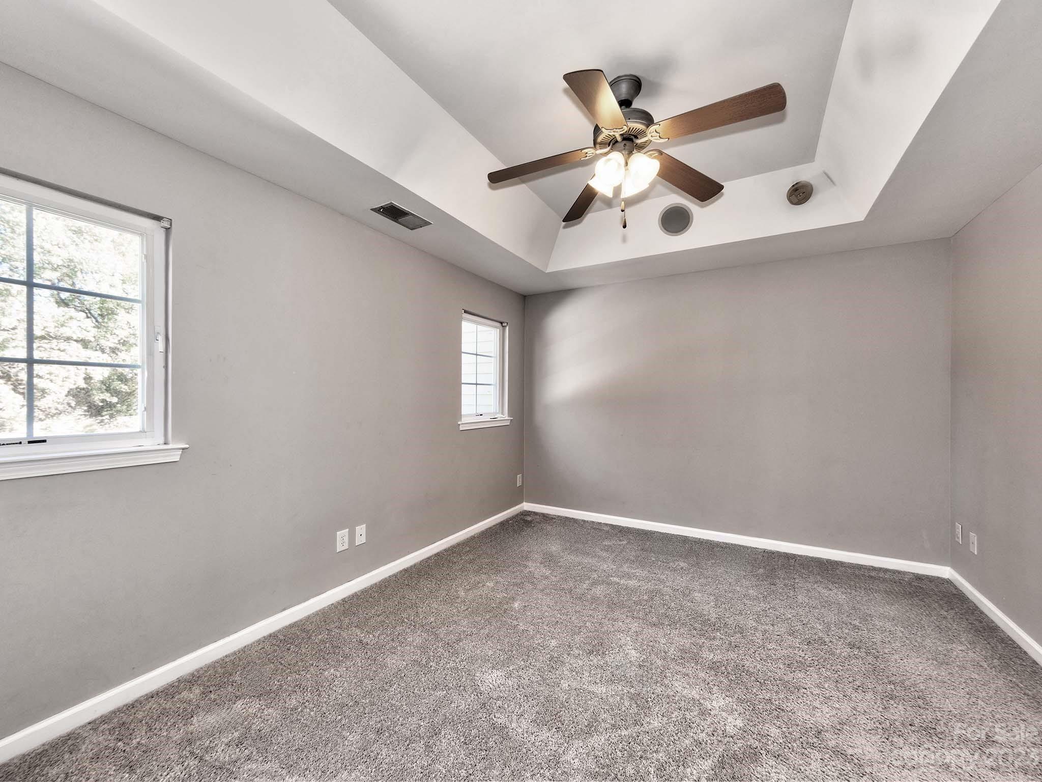 4849 Prosperity Ridge Road Charlotte, NC 28269 - Photo 20 of 40 an empty room with window and ceiling fan