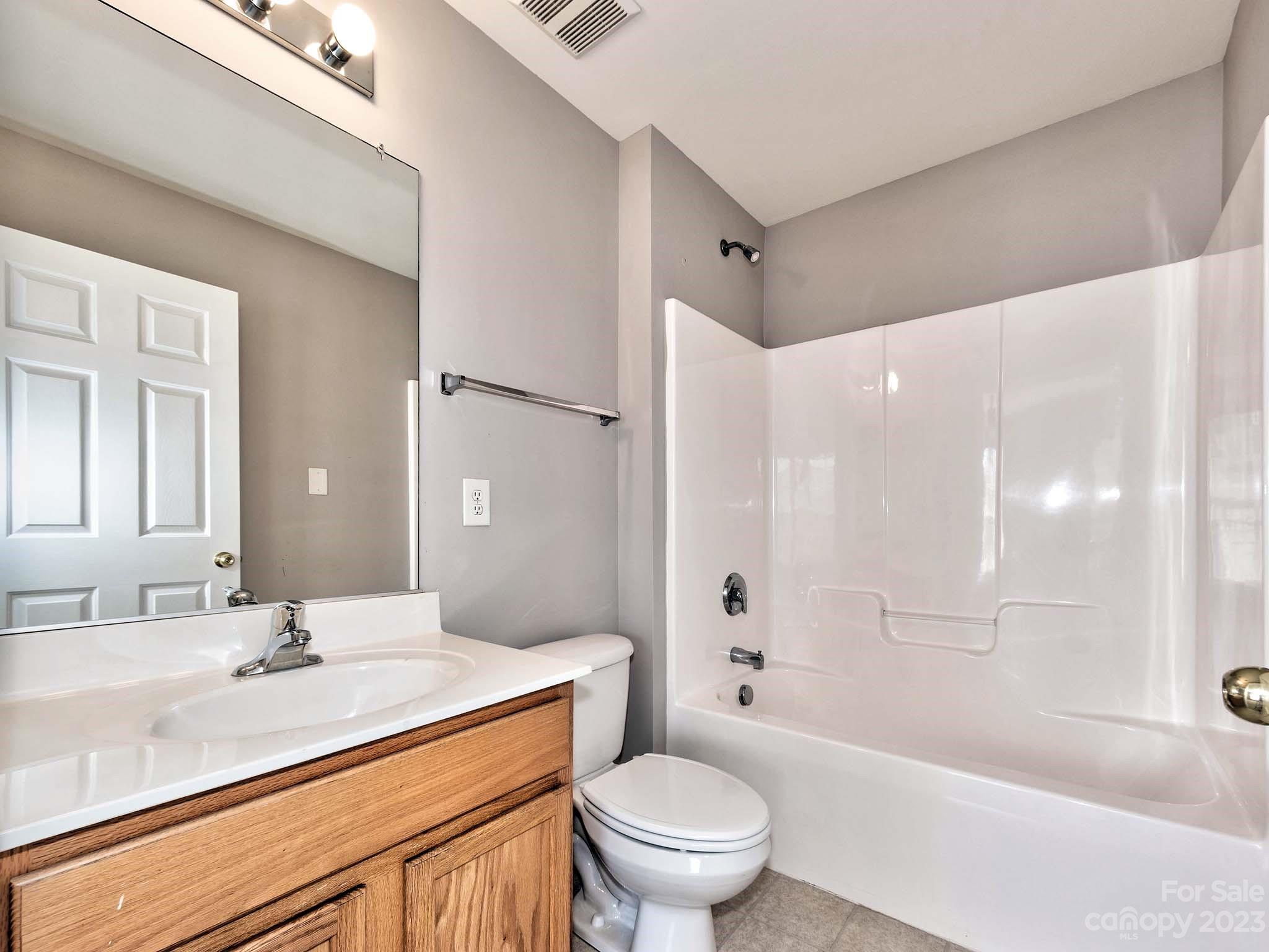 4849 Prosperity Ridge Road Charlotte, NC 28269 - Photo 31 of 40 a bathroom with a sink a toilet and shower
