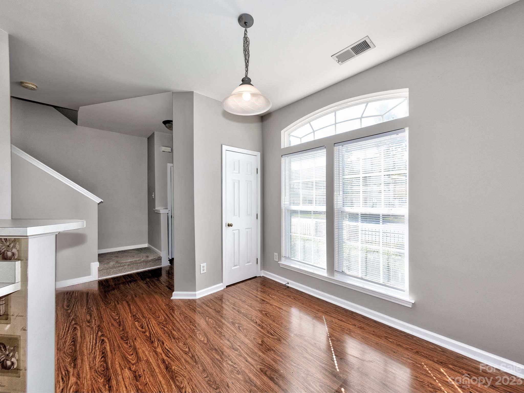 4849 Prosperity Ridge Road Charlotte, NC 28269 - Photo 4 of 40 a view of an empty room with wooden floor and a window