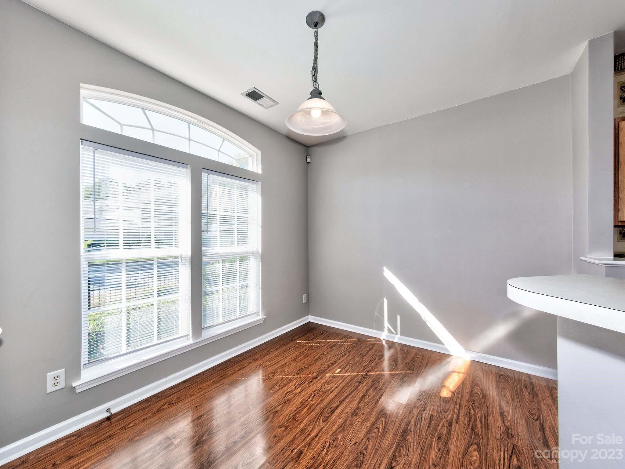 4849 Prosperity Ridge Road Charlotte, NC 28269 - Photo 5 of 40 a view of an empty room with wooden floor and a window