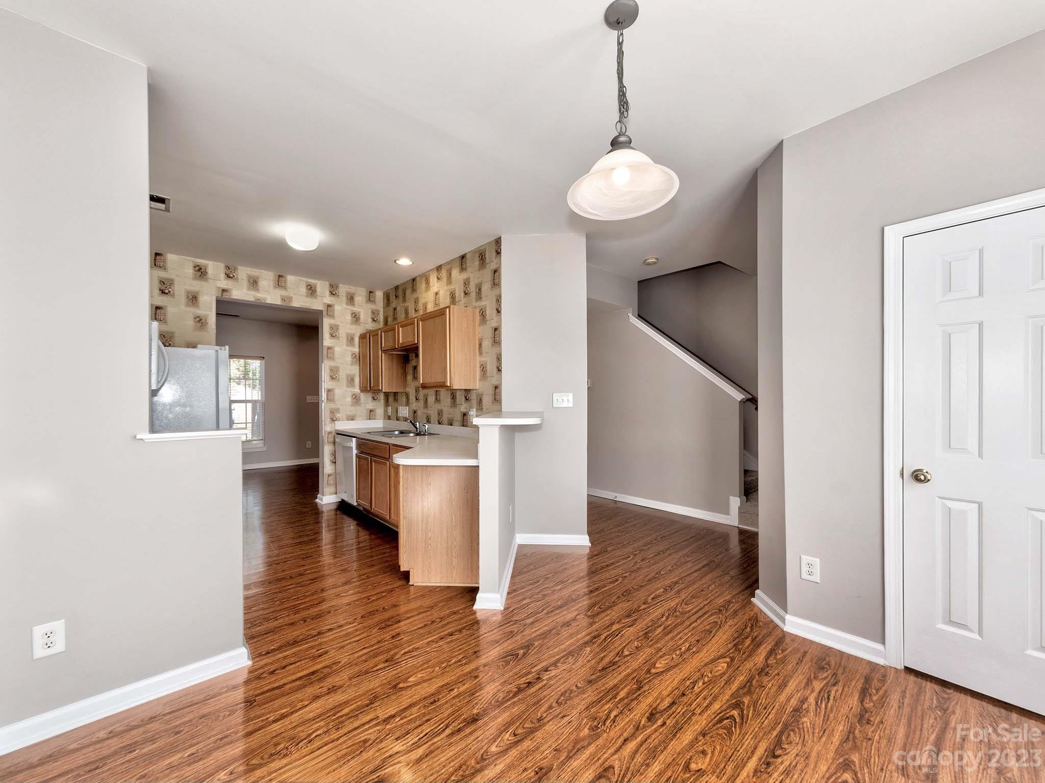 4849 Prosperity Ridge Road Charlotte, NC 28269 - Photo 6 of 40 a view of a kitchen with stove and wooden floor
