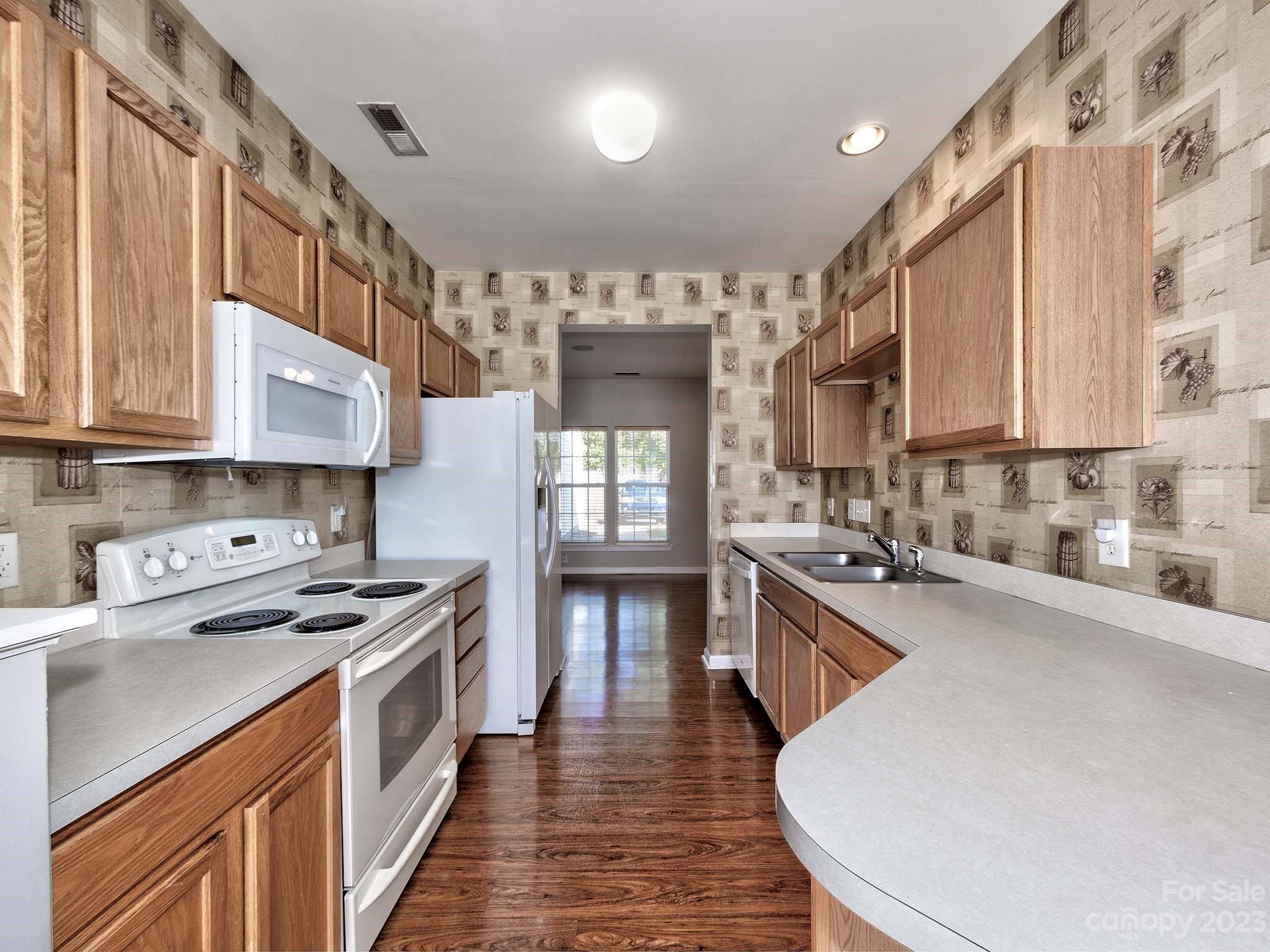 4849 Prosperity Ridge Road Charlotte, NC 28269 - Photo 8 of 40 a kitchen with stainless steel appliances a sink stove and cabinets