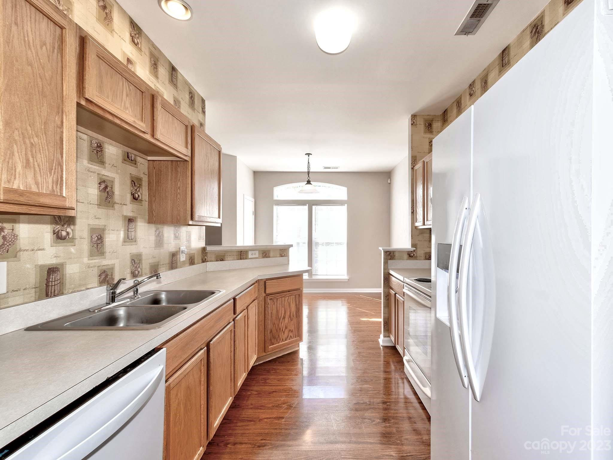 4849 Prosperity Ridge Road Charlotte, NC 28269 - Photo 9 of 40 a kitchen with lots of counter top space and wooden floor