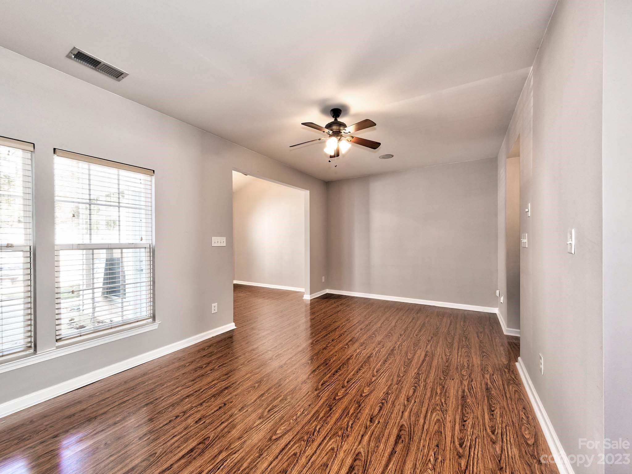 4849 Prosperity Ridge Road Charlotte, NC 28269 - Photo 10 of 40 a view of an empty room with a window and wooden floor