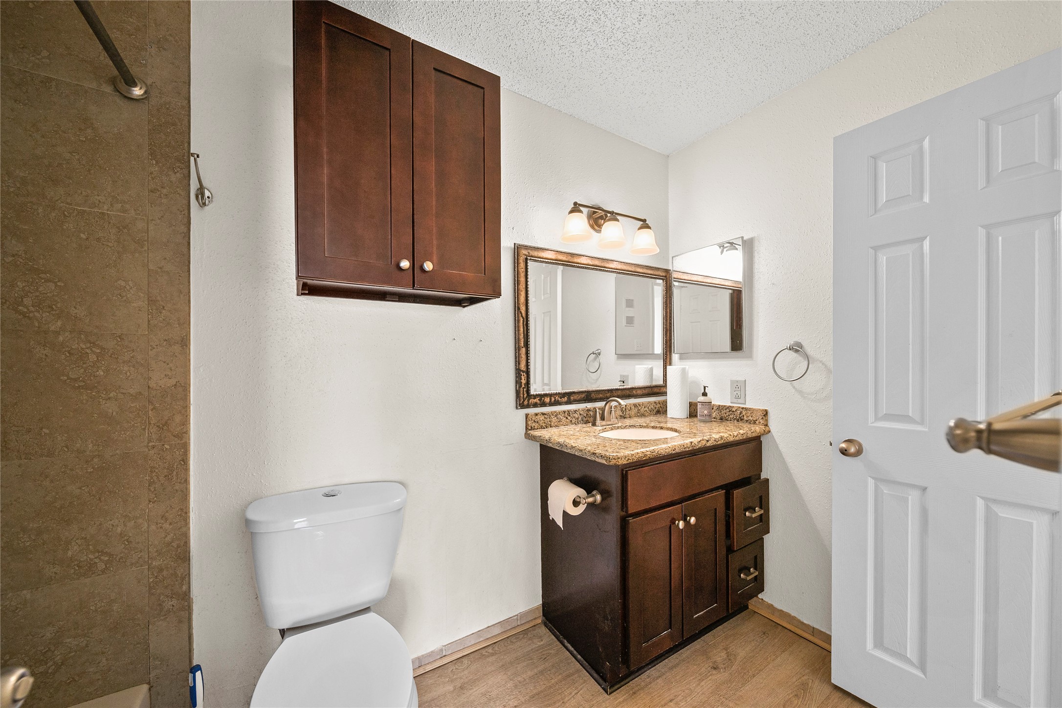 2750 Holly Hall Street, Unit 714 Houston, TX 77054 - Photo 12 of 18 a bathroom with a sink a toilet and mirror