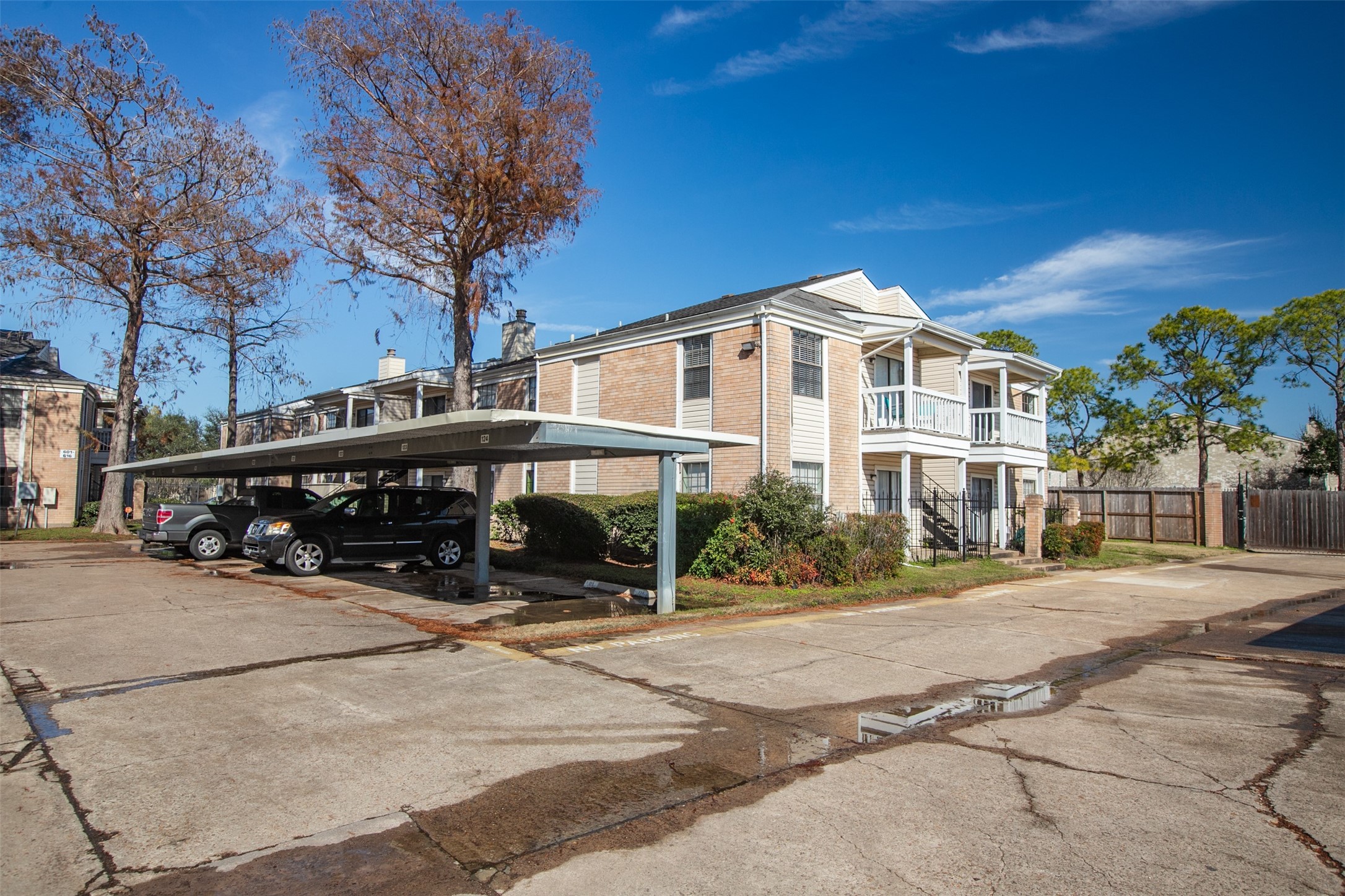 2750 Holly Hall Street, Unit 714 Houston, TX 77054 - Photo 16 of 18 a front view of a house with a garden