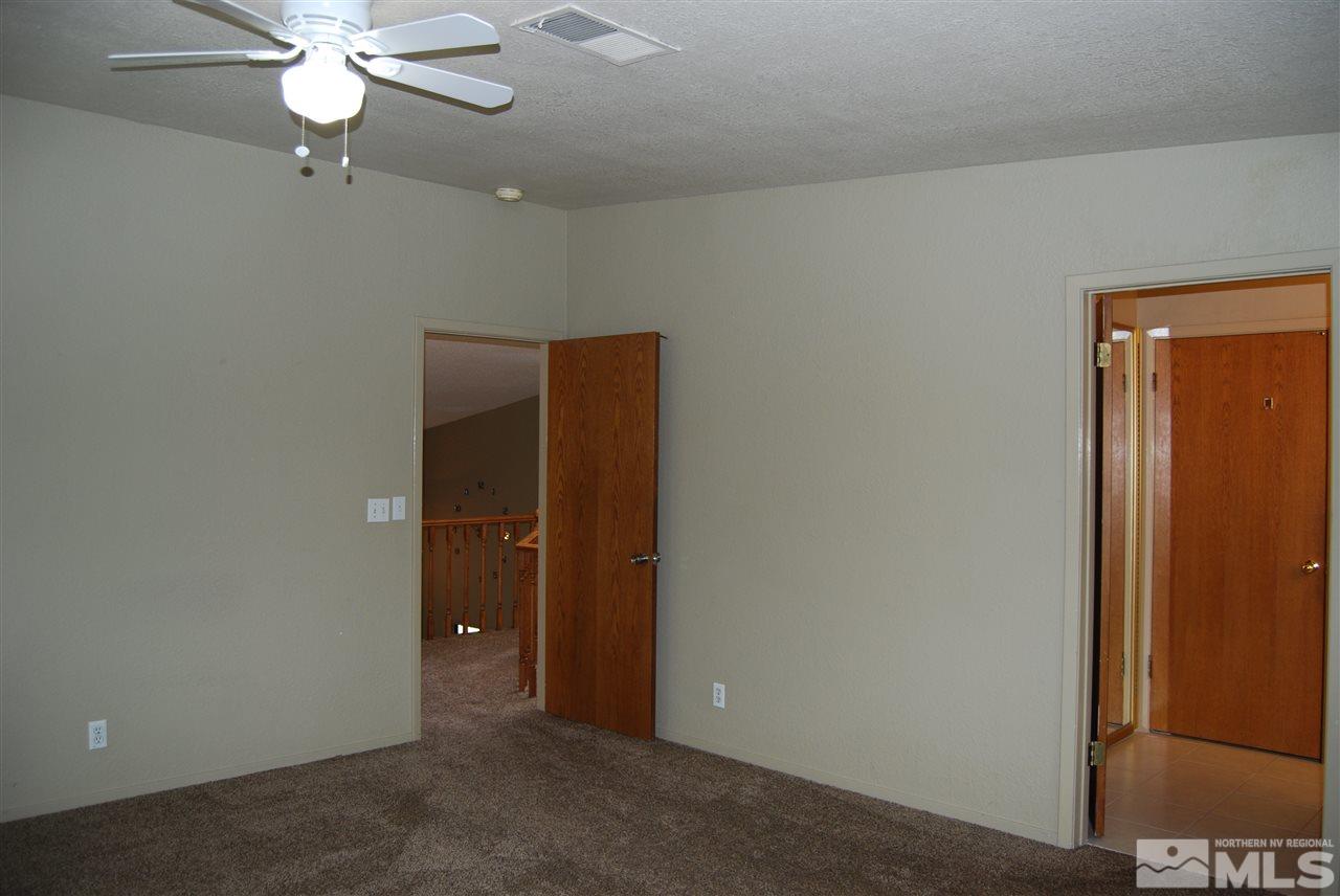 7110 Lighthouse Lane Reno, NV 89511 - Photo 29 of 40 a view of an empty room with a ceiling fan