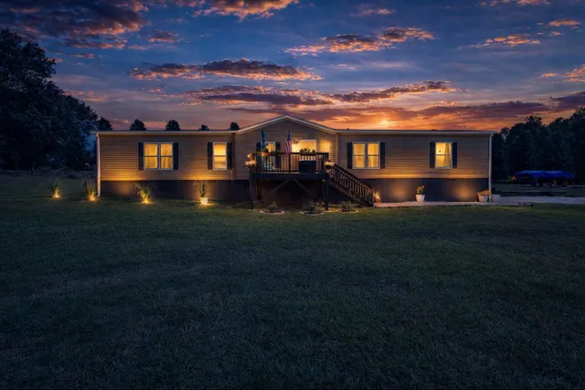 a view of house with a big yard