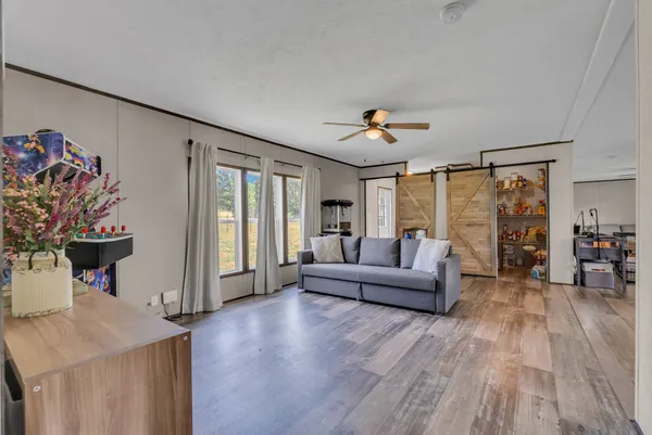 a living room with furniture and wooden floor