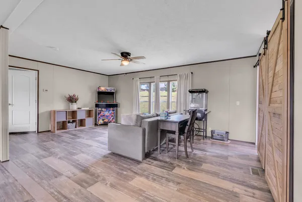 a living room with fireplace furniture and a wooden floor