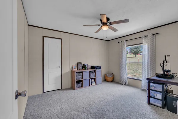 a view of a livingroom with furniture and a ceiling fan