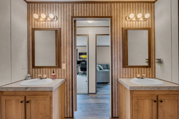 a bathroom with a sink a mirror and a vanity