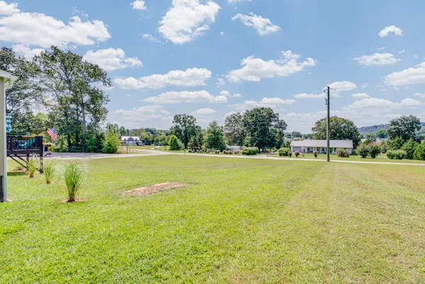 a view of a house with a yard and sitting area
