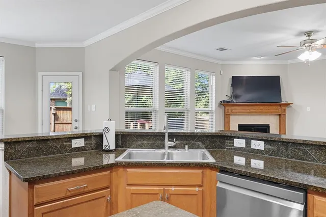 a kitchen with granite countertop a sink and a stove