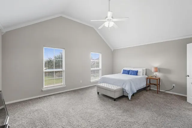 a spacious bedroom with a bed and a window