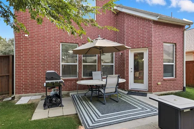 a patio with table and chairs
