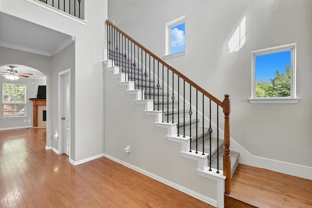 a view of entryway and hall with wooden floor