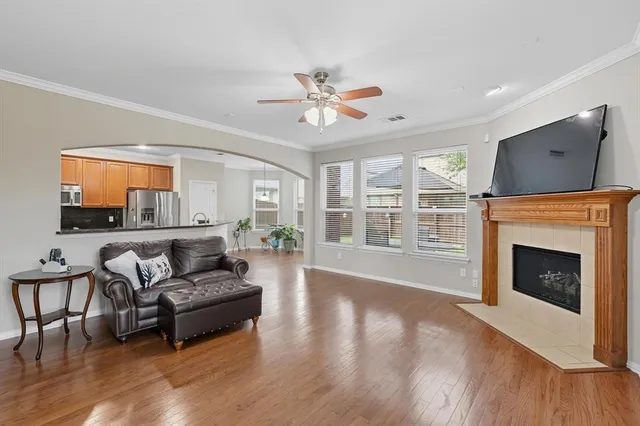 a living room with furniture a fireplace and a flat screen tv
