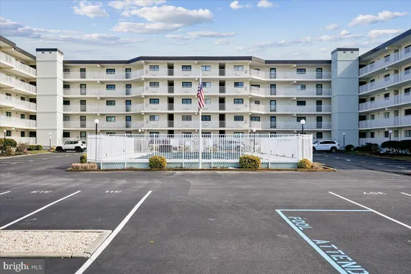 a view of building with parking area