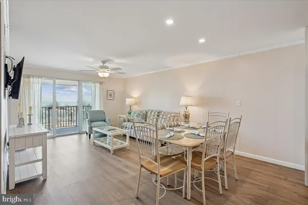 a view of a dining room with furniture wooden floor and a flat screen tv