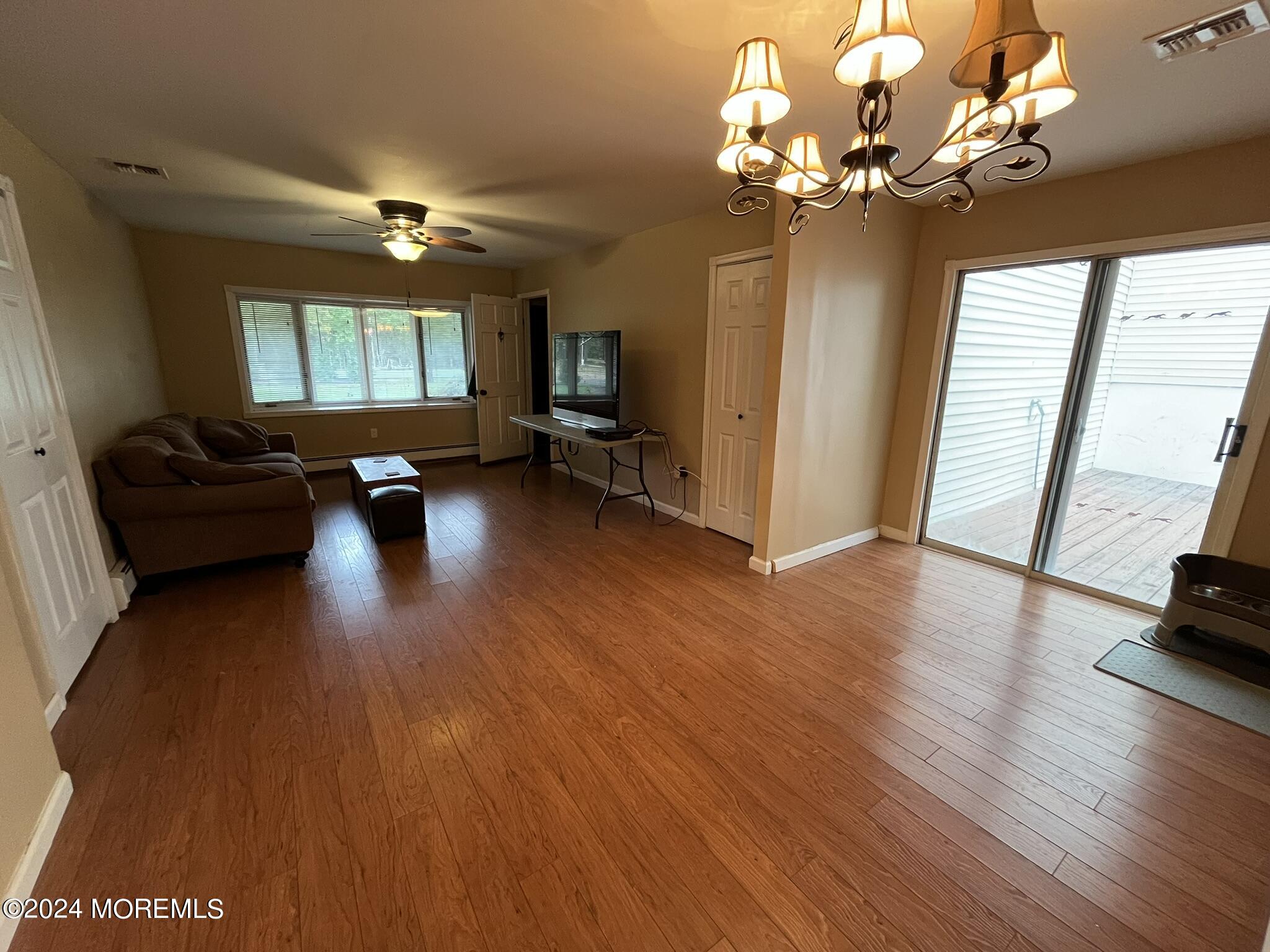 189 Tennent Road Morganville, NJ 07751 - Photo 23 of 45 a view of a livingroom with furniture wooden floor and windows