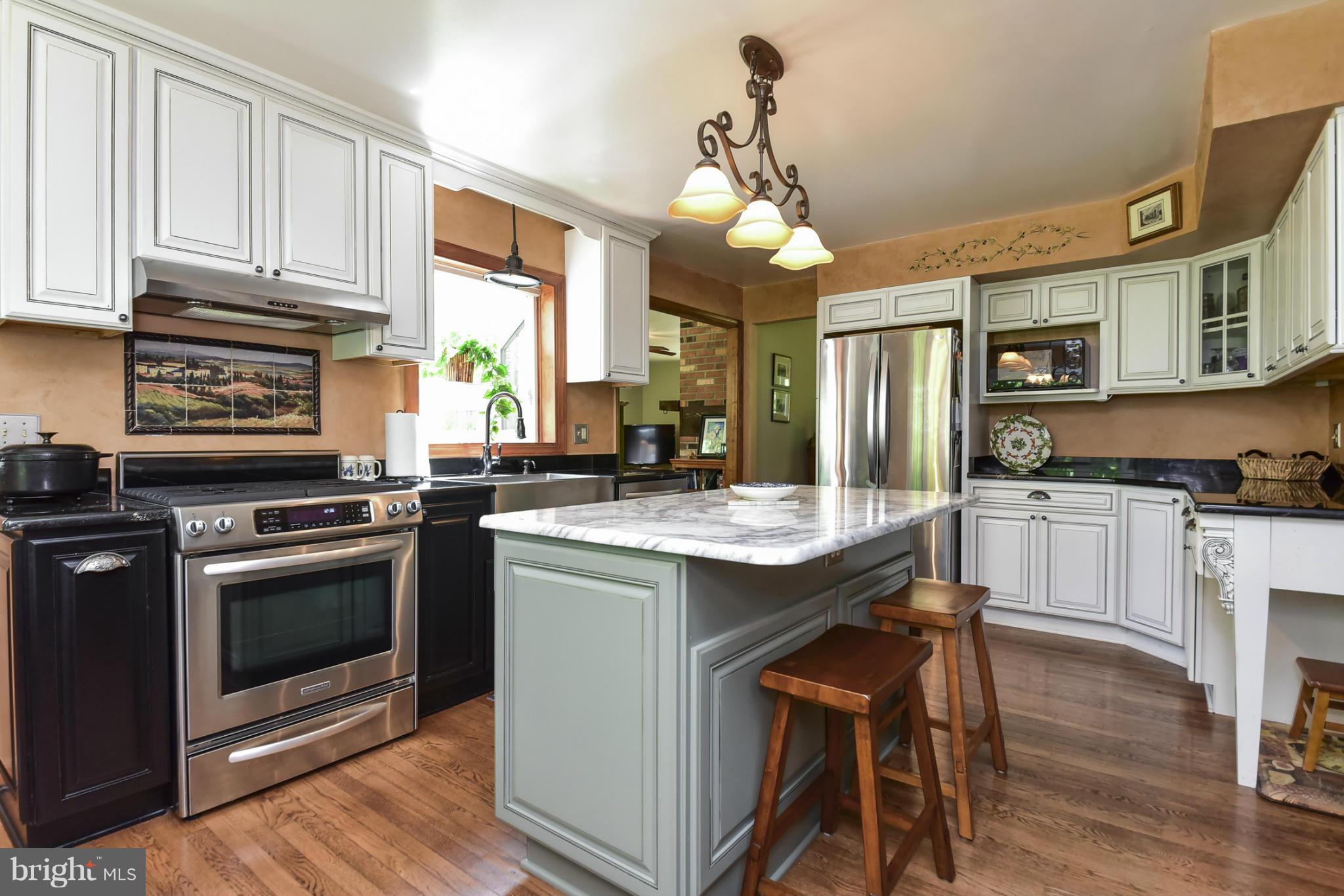 8033 Waterloo Farm Road Warrenton, VA 20186 - Photo 12 of 30 a kitchen with stainless steel appliances granite countertop a stove and a refrigerator