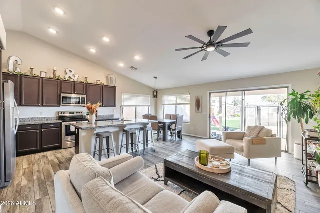 a living room with lots of furniture and kitchen view