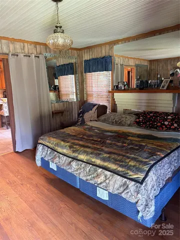 a bedroom with a bed and a chandelier