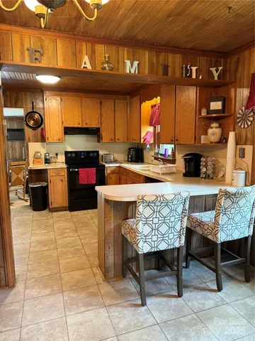 a kitchen with a stove a sink and a microwave