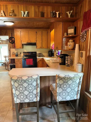 a living room with furniture and a kitchen
