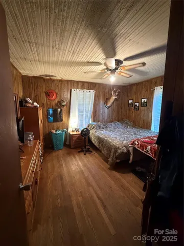 a bedroom with furniture and a ceiling fan