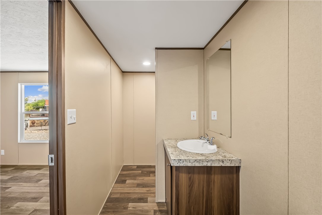 13205 South Water Reed Way Topock, AZ 86436 - Photo 25 of 37 a bathroom with a granite countertop sink and a mirror