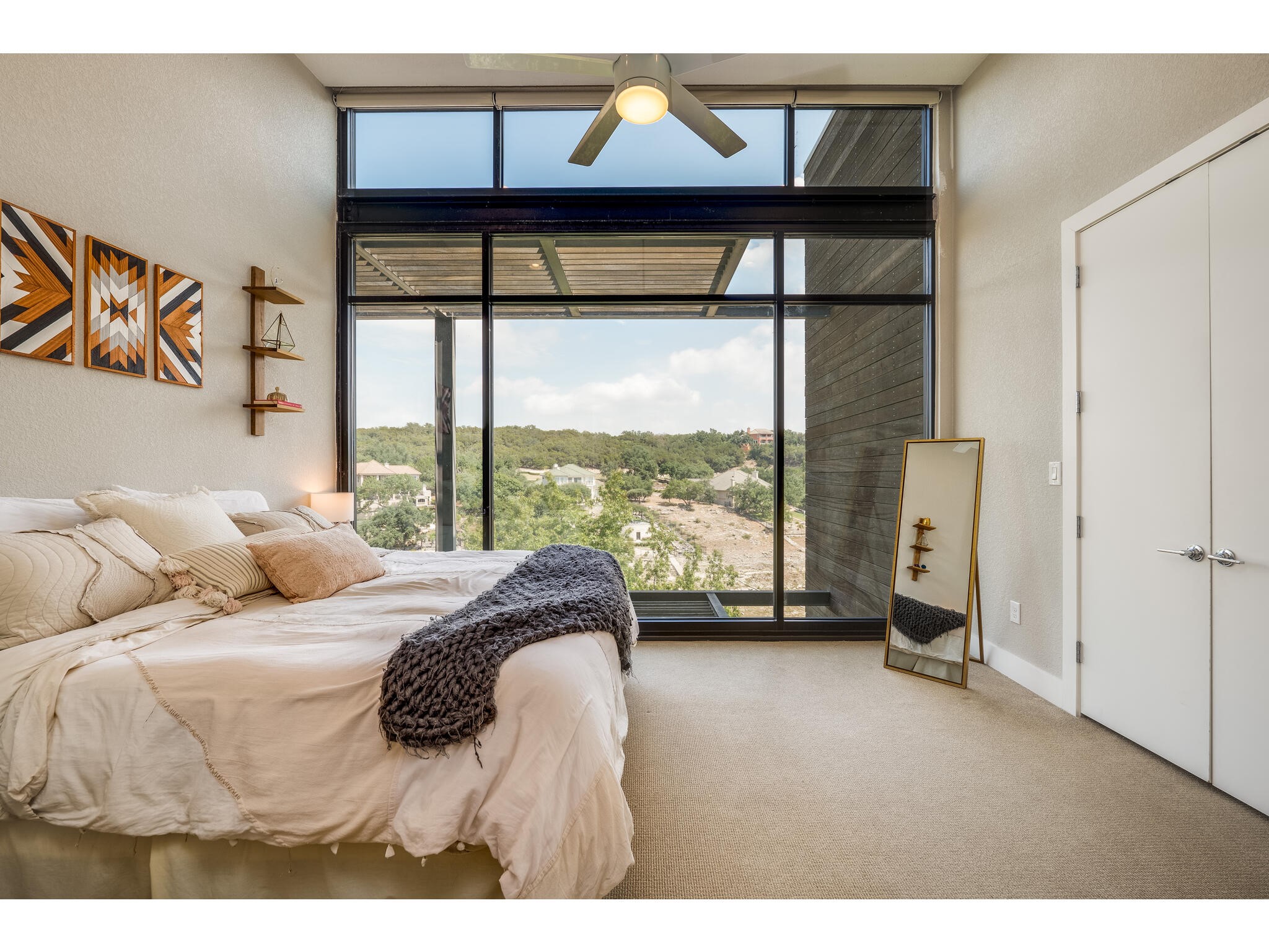 1101 Ivean Pearson Road, Unit A203 Lago Vista, TX 78645 - Photo 4 of 27 The primary bedroom is a
sanctuary, featuring floor-toceiling windows offering stunning
views and a huge walk-in
closet for all your storage needs.