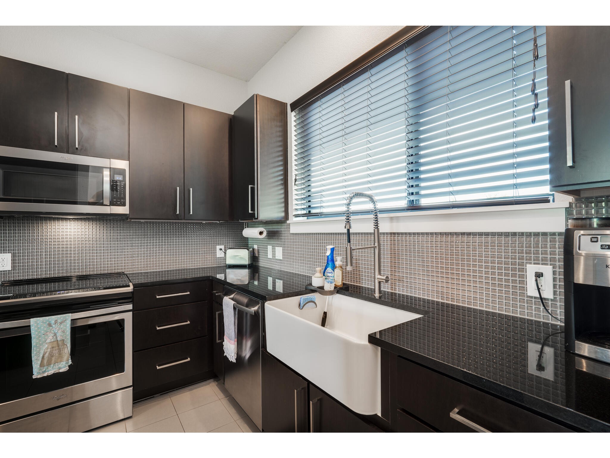 1101 Ivean Pearson Road, Unit A203 Lago Vista, TX 78645 - Photo 6 of 27 This modern kitchen is equipped
with stainless steel appliances
and a deep single basin farmhouse sink.