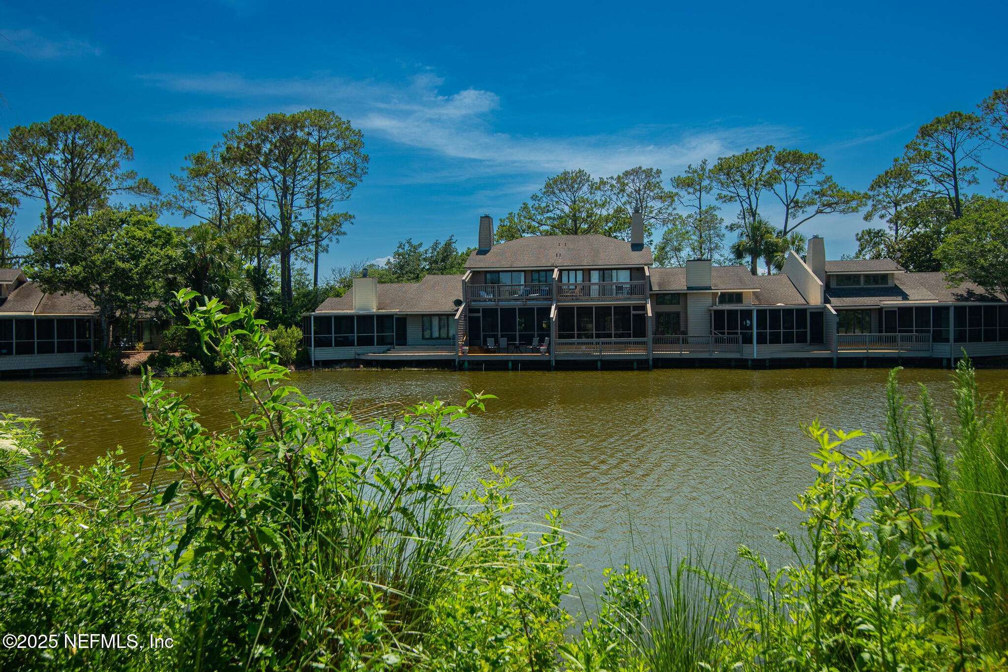 36 Fishermans Cove Road Ponte Vedra Beach, FL 32082 - Photo 23 of 51 a view of a swimming pool with lawn chairs under an umbrella