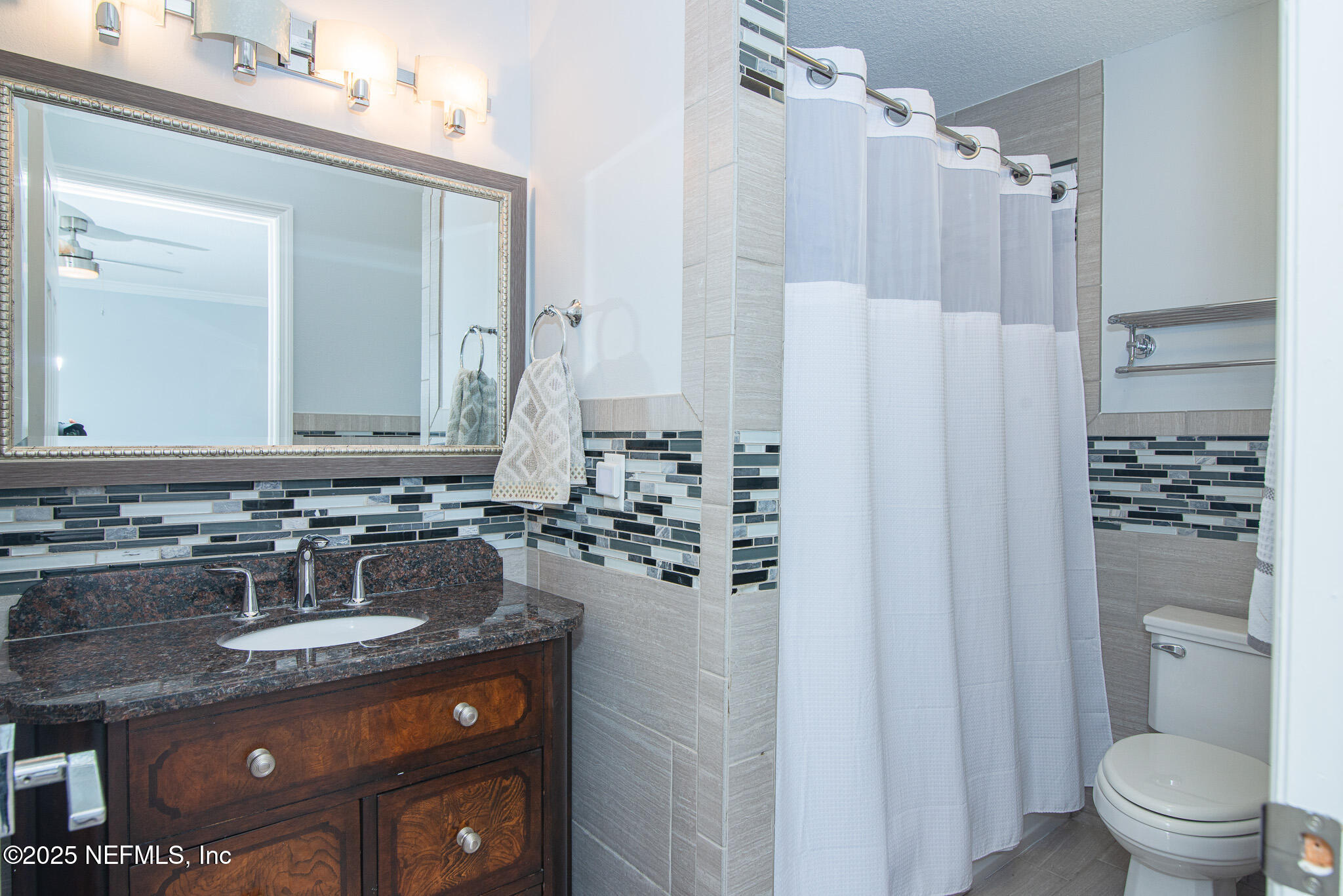 36 Fishermans Cove Road Ponte Vedra Beach, FL 32082 - Photo 36 of 51 a bathroom with a granite countertop sink a toilet a mirror and shower