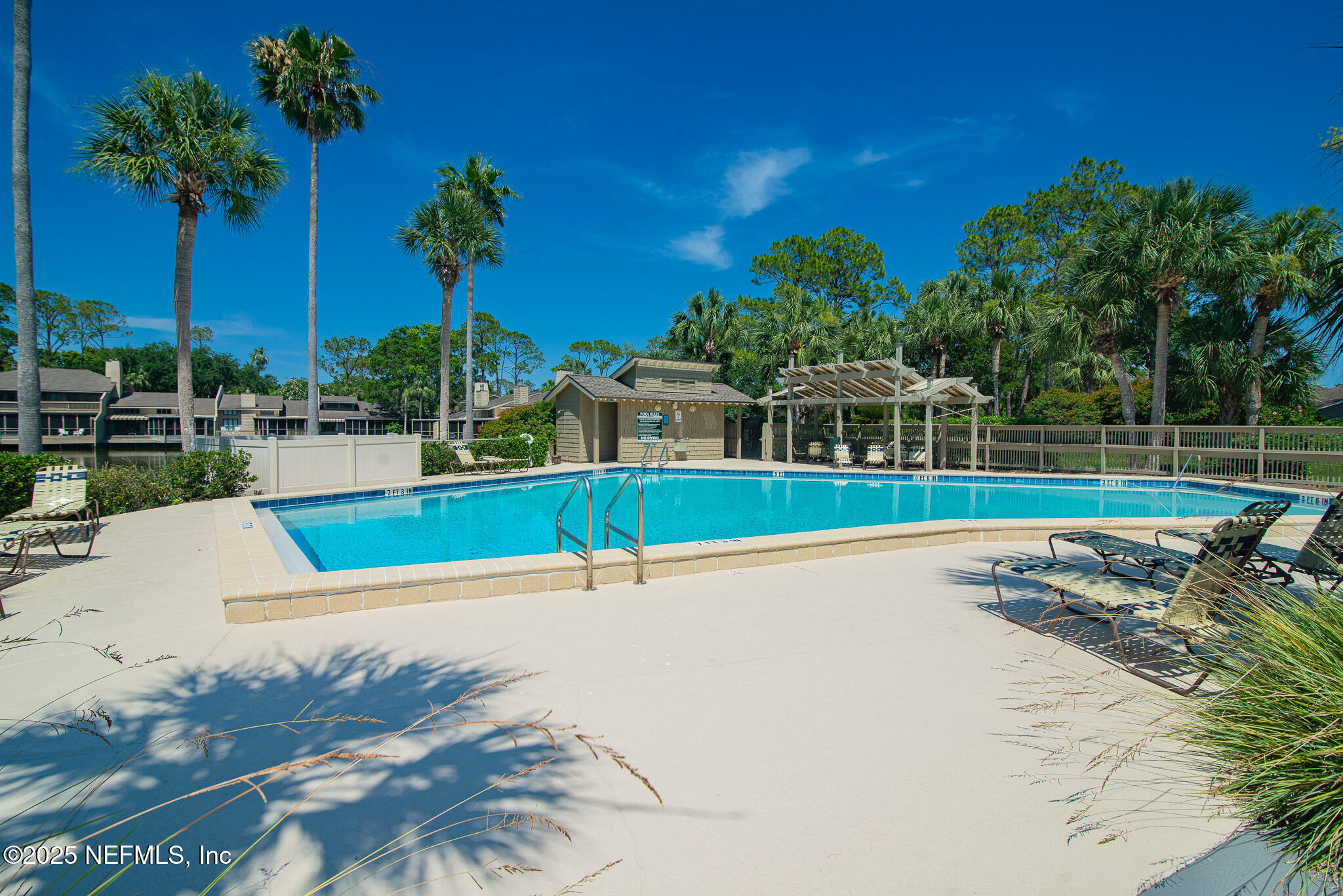 36 Fishermans Cove Road Ponte Vedra Beach, FL 32082 - Photo 43 of 51 a view of a swimming pool with a yard and palm trees