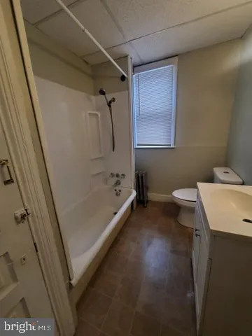 a bathroom with a tub sink and toilet