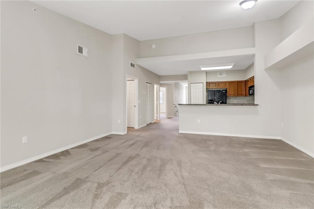 20160 Estero Gardens Circle, Unit 202 Estero, FL 33928 - Photo 11 of 44 a view of a kitchen with a sink and a dishwasher