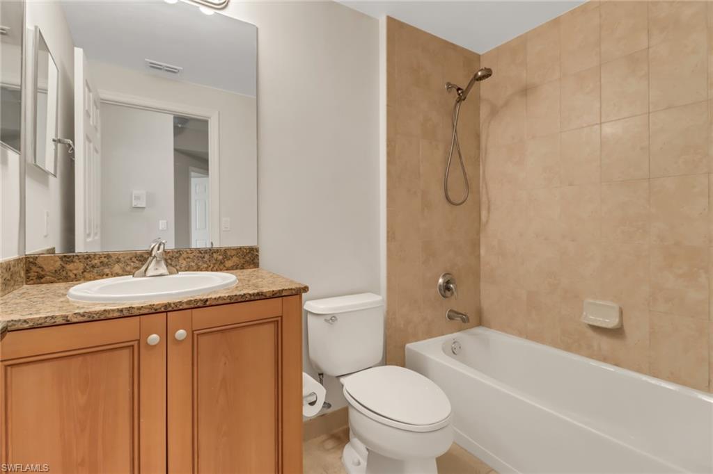 20160 Estero Gardens Circle, Unit 202 Estero, FL 33928 - Photo 21 of 44 a bathroom with a granite countertop sink toilet and shower