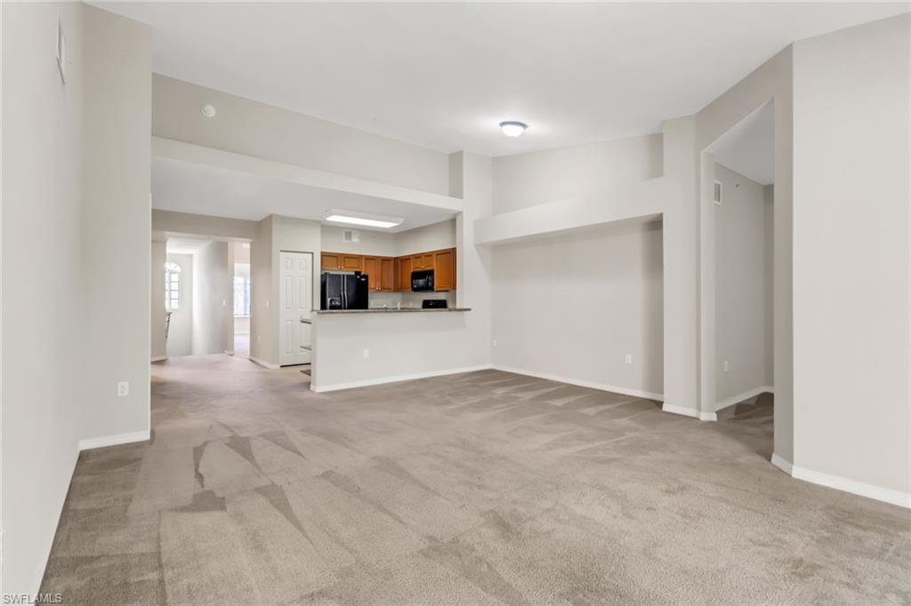 20160 Estero Gardens Circle, Unit 202 Estero, FL 33928 - Photo 4 of 44 a view of a big room with closet and windows